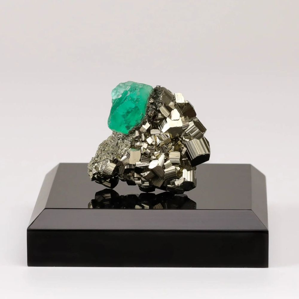 Fluorite of Fire, a green fluorite crystal on golden pyrite cubes